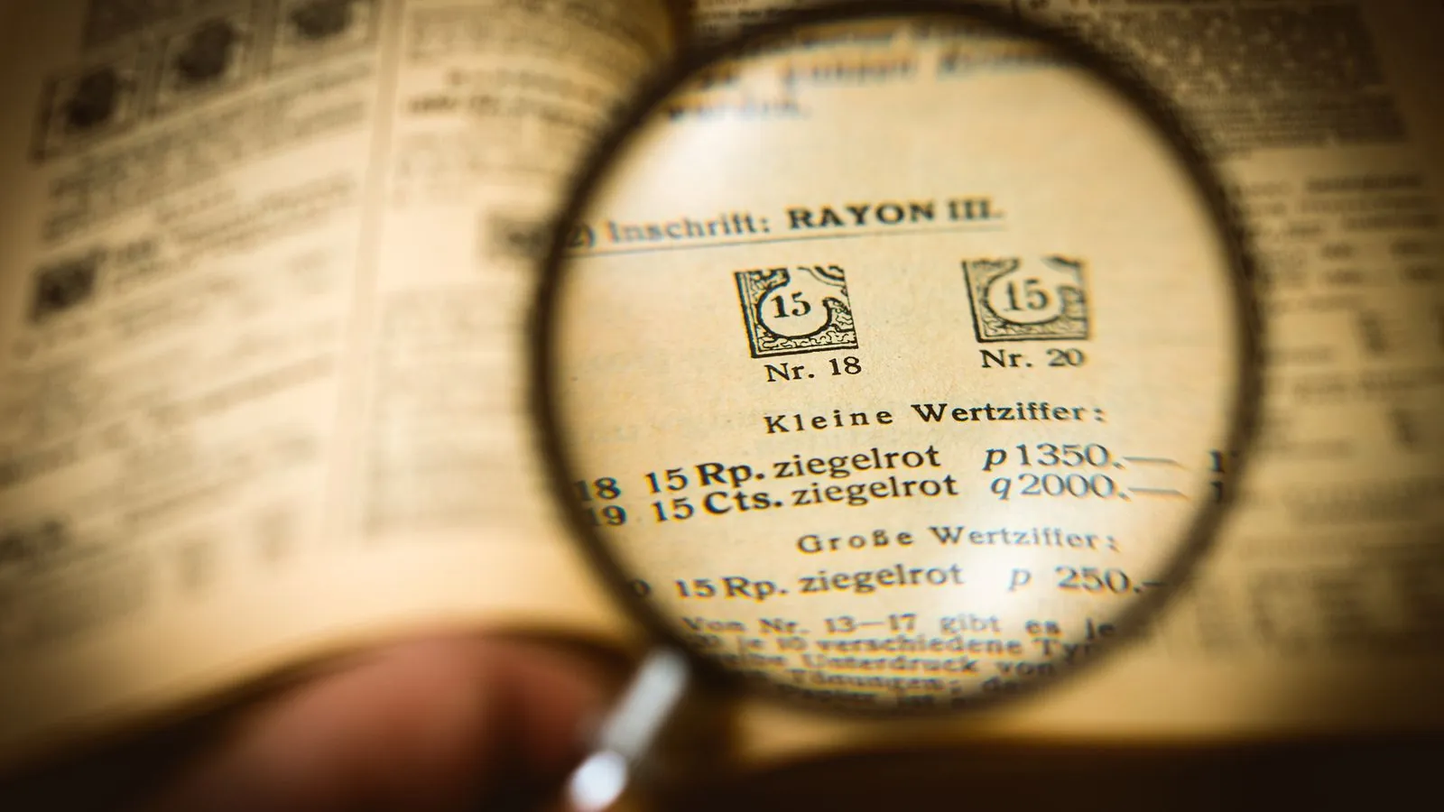 Detailed view of a book page magnified by a glass, enhancing text clarity.