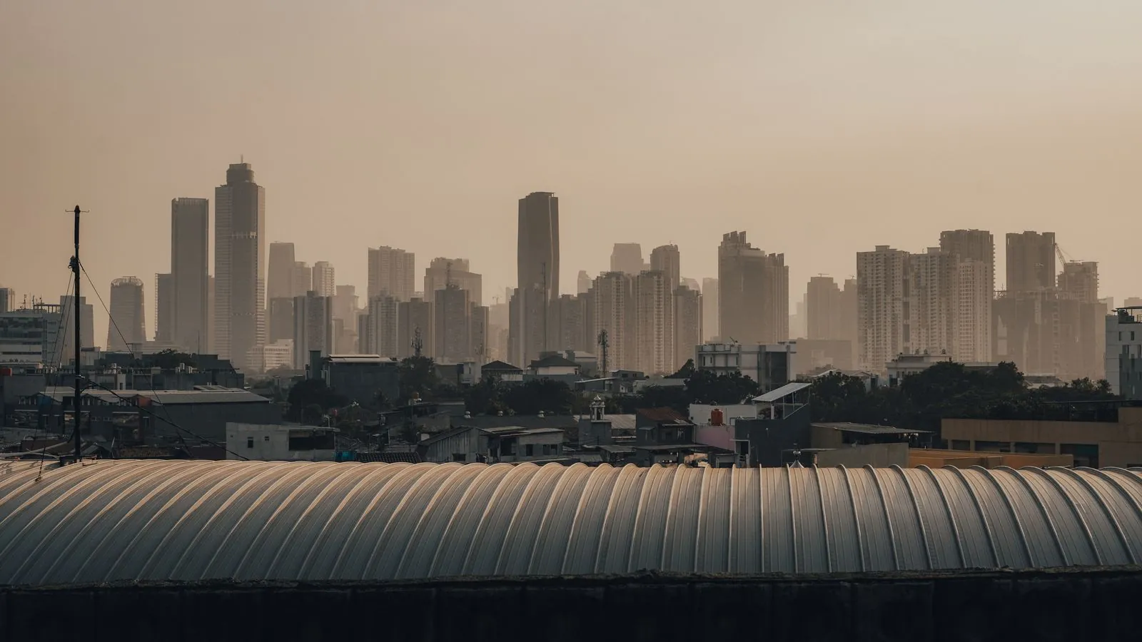Elevated view of Jakarta's skyline with iconic skyscrapers at dusk, showcasing urban architecture.