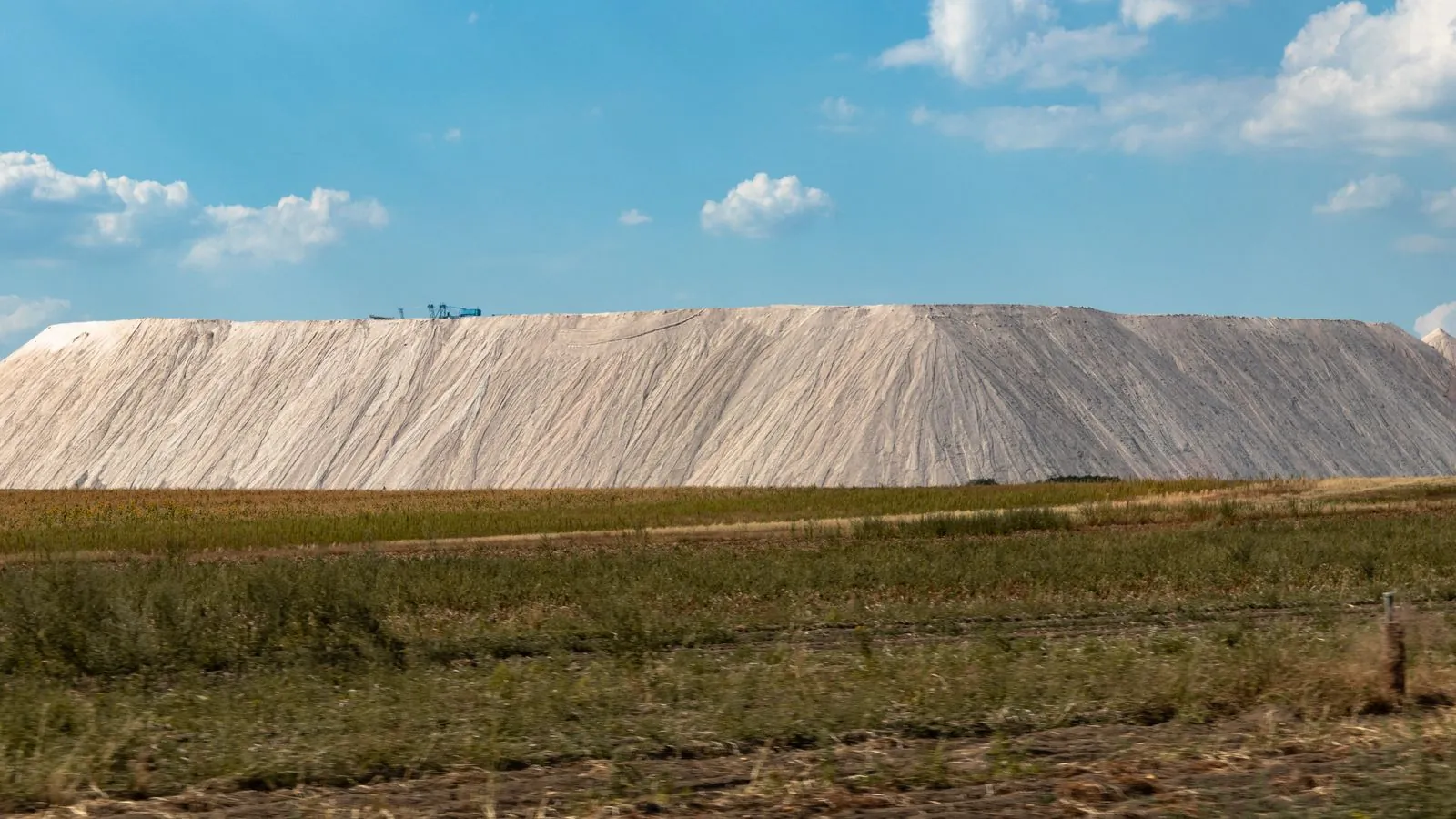Expansive salt mine landscape with clear blue sky, capturing natural industry outdoors.