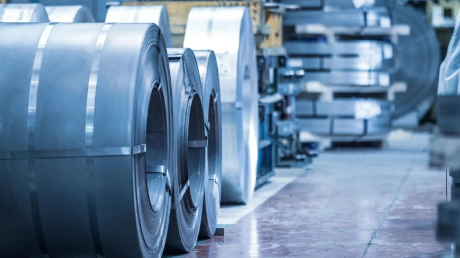Close-up of coiled metal sheets in an industrial factory. Precision engineering materials.