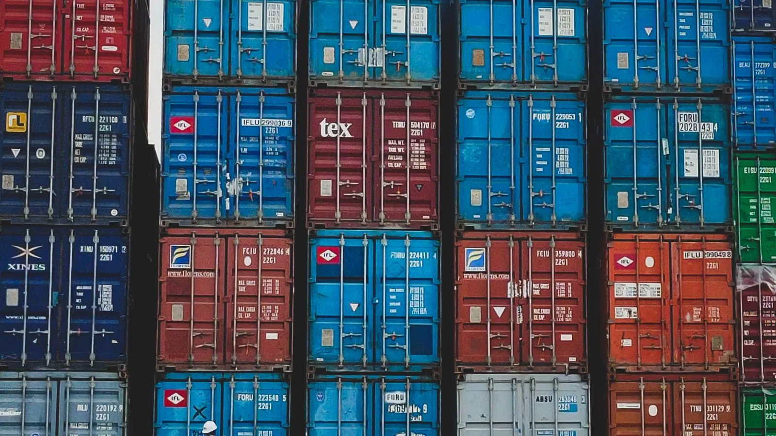 Colorful stacked cargo containers at a shipping yard in Jakarta, Indonesia.
